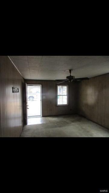 empty room with plenty of natural light and ceiling fan