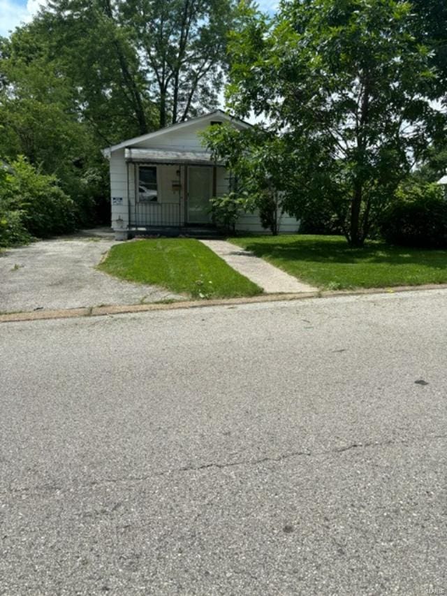 bungalow with a porch and a front yard