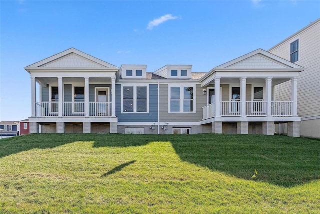 back of house with a balcony, a lawn, and covered porch