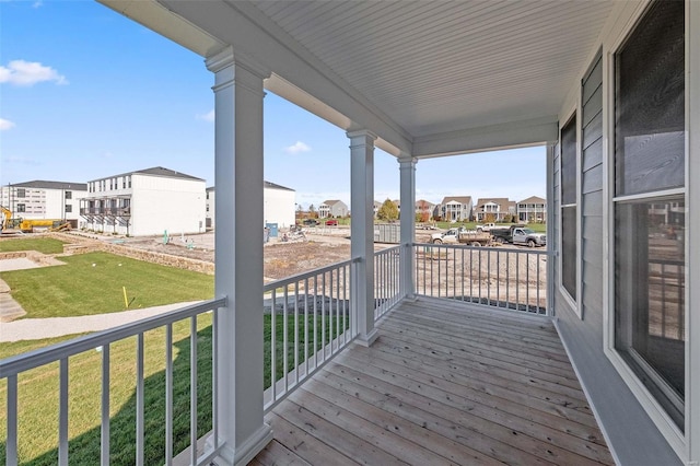 deck with a lawn and covered porch