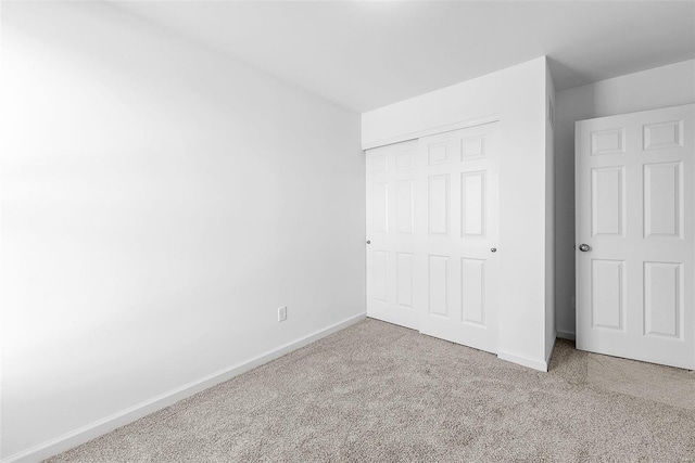 unfurnished bedroom with carpet and a closet