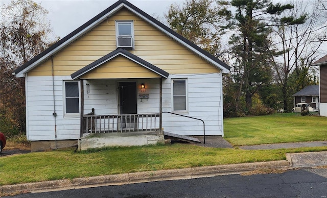 bungalow with a porch and a front lawn