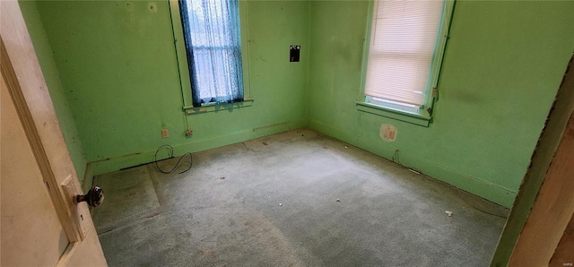 empty room featuring plenty of natural light and light carpet