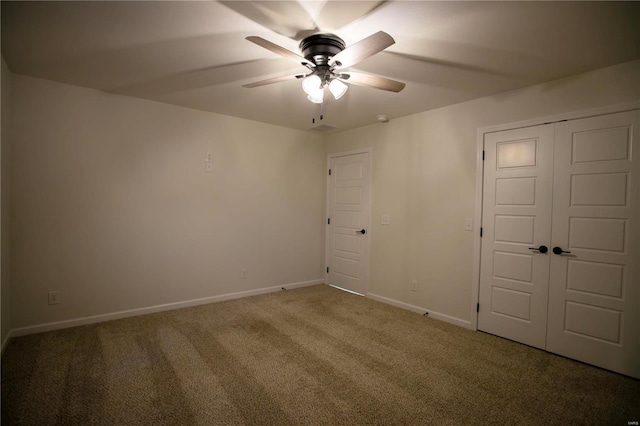 unfurnished bedroom featuring carpet flooring, ceiling fan, and a closet