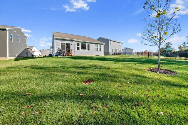 rear view of house featuring a lawn