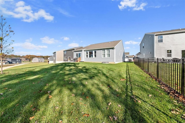 rear view of house with a yard