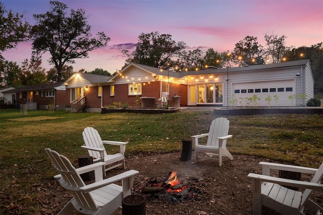 view of front of house featuring a garage and a lawn