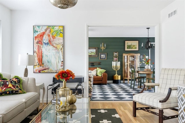 living area featuring hardwood / wood-style flooring and wooden walls