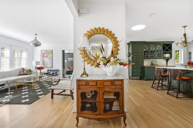 interior space featuring light hardwood / wood-style flooring and a chandelier