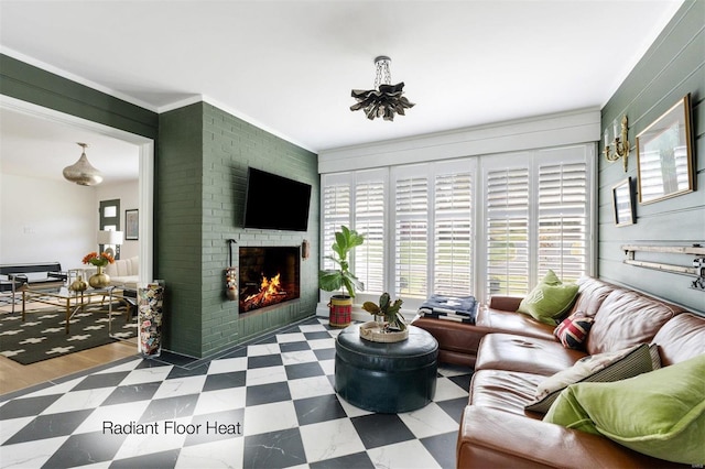 living room with hardwood / wood-style floors, a brick fireplace, and ornamental molding