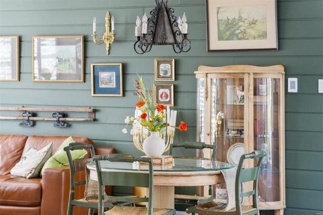 dining space featuring wood walls