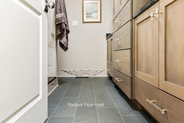 mudroom featuring dark tile patterned flooring