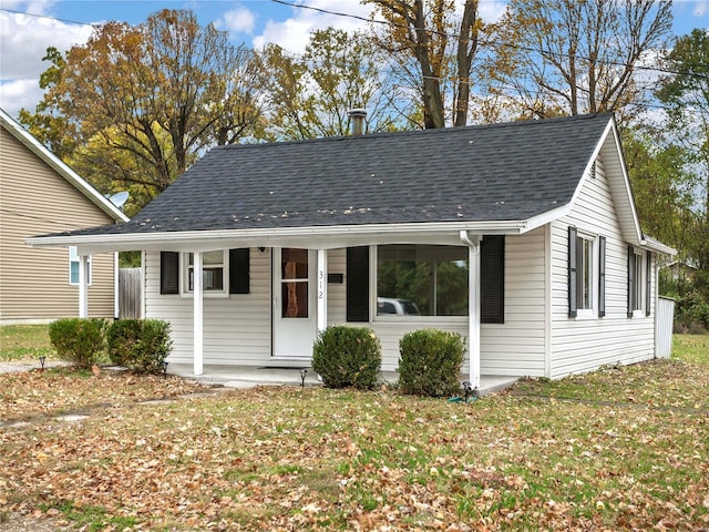 view of front of property with a front yard and covered porch