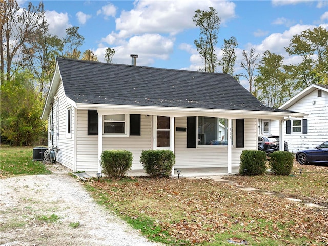 bungalow-style house featuring central air condition unit and a porch