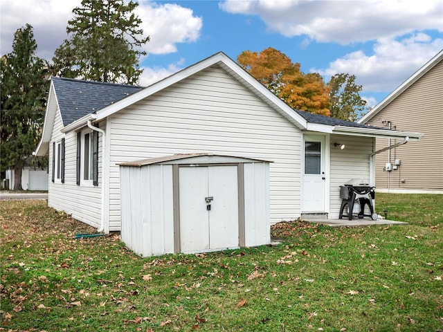 back of property with a lawn and a storage shed