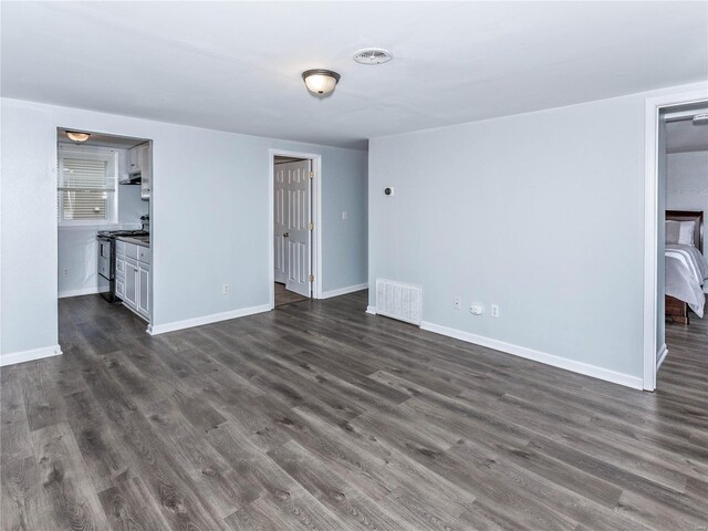 unfurnished living room featuring dark hardwood / wood-style flooring