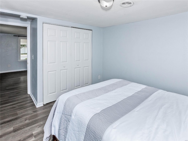 bedroom featuring dark hardwood / wood-style flooring and a closet