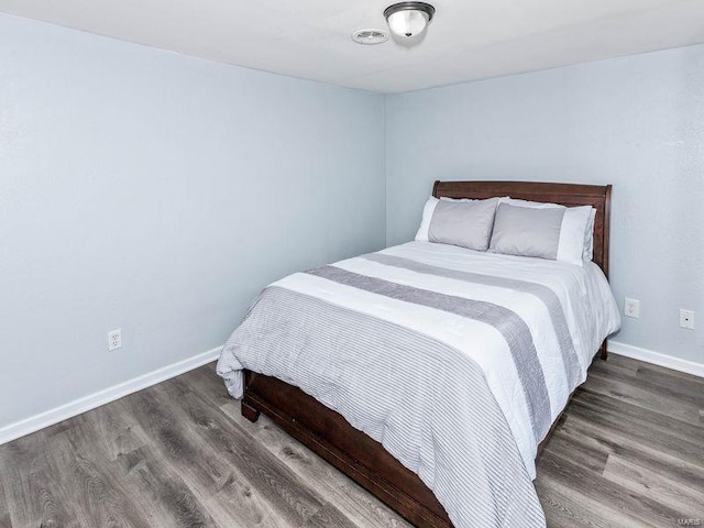 bedroom featuring dark hardwood / wood-style flooring