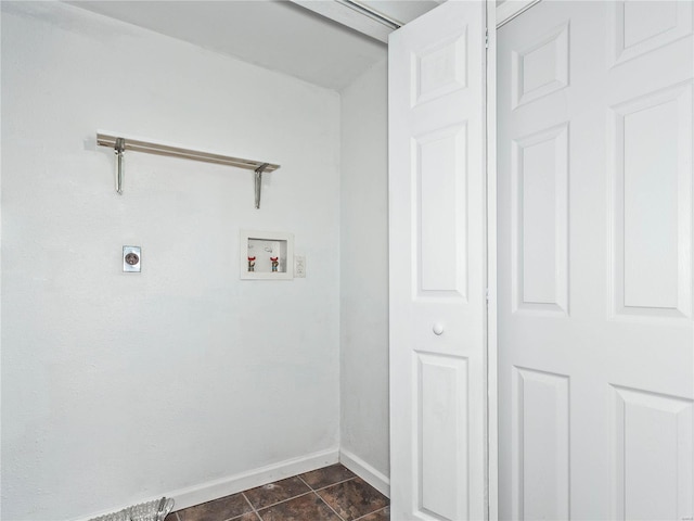 washroom with dark tile patterned floors, hookup for a washing machine, and electric dryer hookup