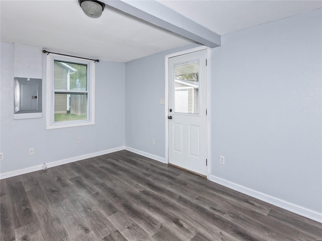 empty room featuring electric panel and dark wood-type flooring