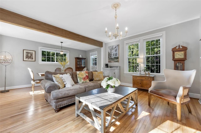 living room featuring beamed ceiling, an inviting chandelier, and light hardwood / wood-style flooring