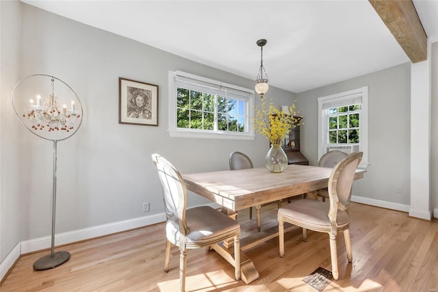 dining room featuring a chandelier and light wood-type flooring