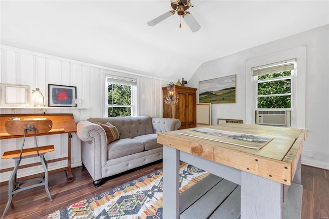 living room with dark wood-type flooring, vaulted ceiling, and a healthy amount of sunlight