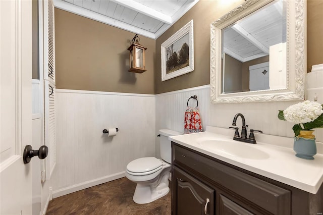 bathroom with beam ceiling, vanity, toilet, and wooden ceiling