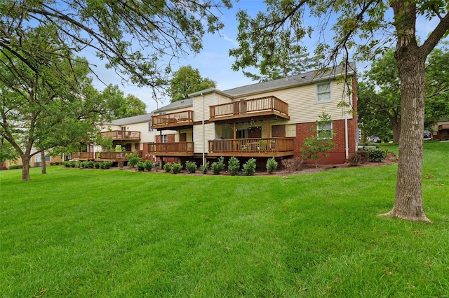 rear view of house with a yard and a deck