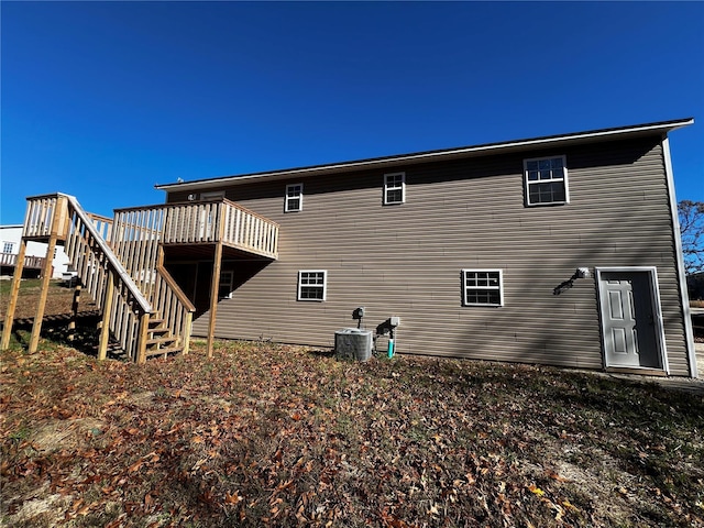 rear view of property with central AC and a deck