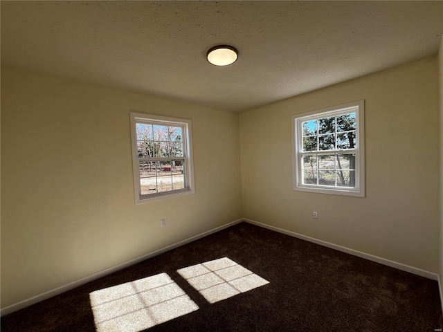 carpeted spare room featuring plenty of natural light