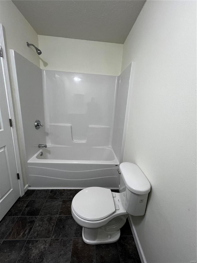 bathroom with tile patterned floors, toilet, and tub / shower combination