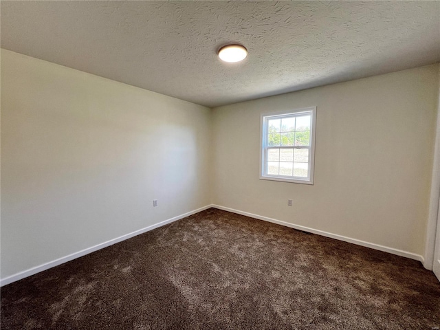 carpeted spare room with a textured ceiling