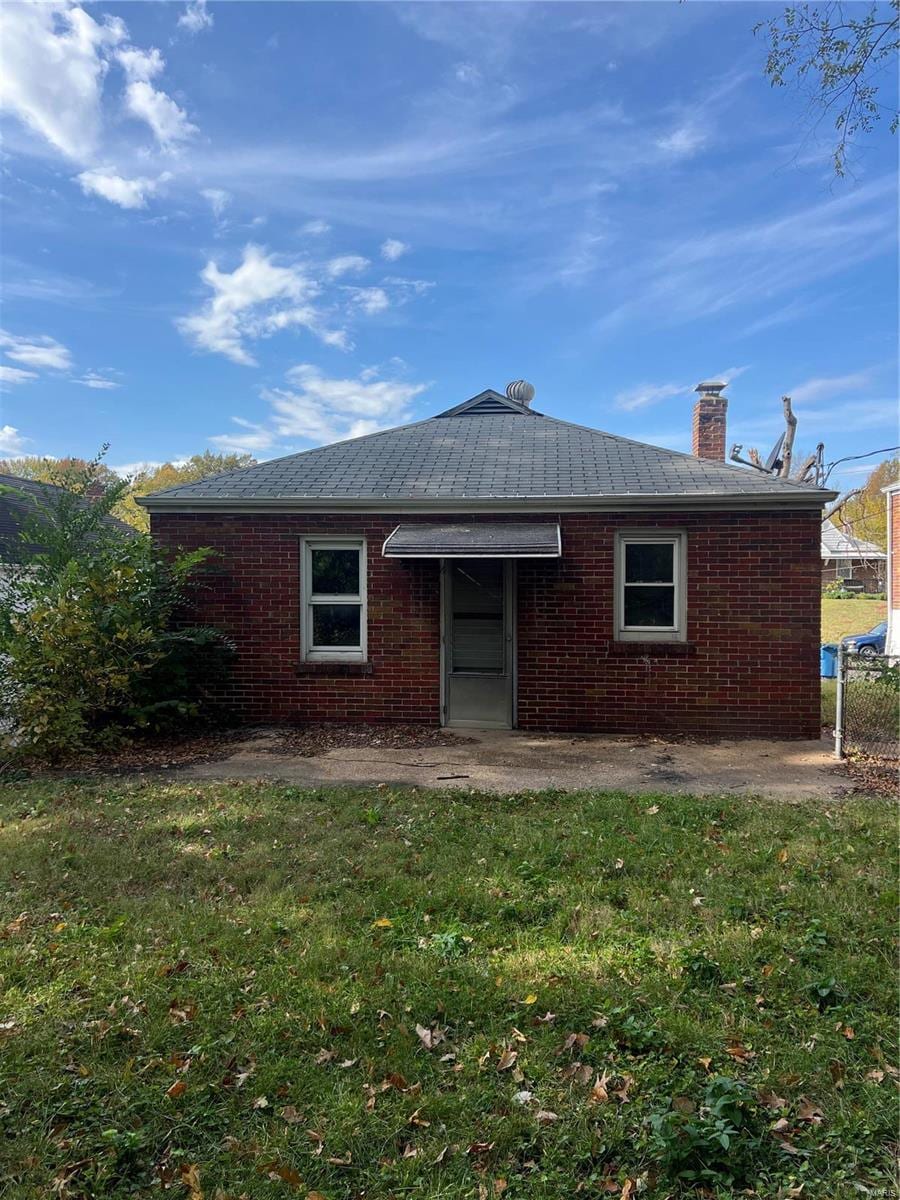 rear view of house with a lawn