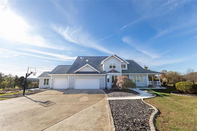 view of front of property with a front yard and a garage