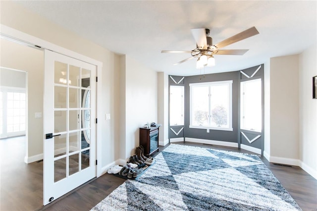 interior space featuring ceiling fan, dark hardwood / wood-style flooring, and french doors