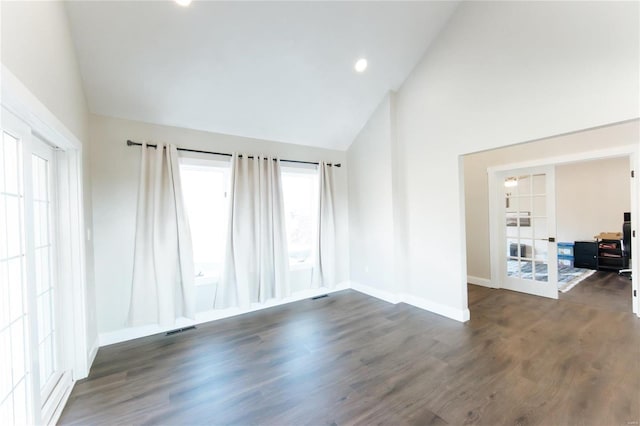 unfurnished room with french doors, high vaulted ceiling, and dark wood-type flooring