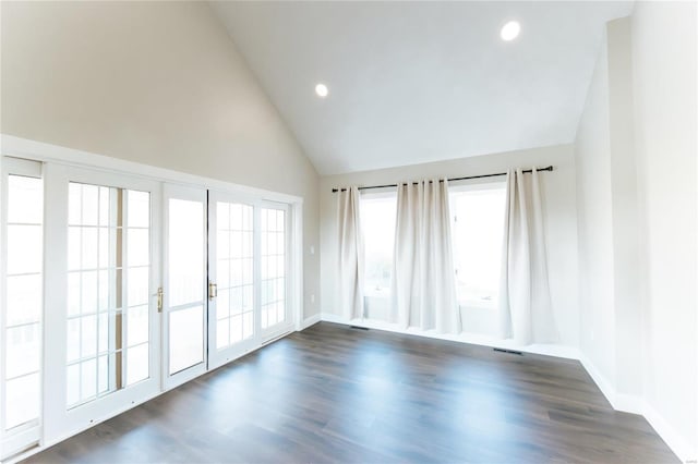 empty room featuring dark hardwood / wood-style flooring and high vaulted ceiling