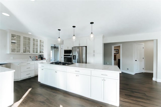 kitchen with a center island, hanging light fixtures, dark hardwood / wood-style floors, white cabinetry, and stainless steel appliances