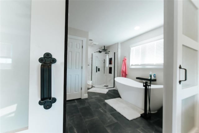 bathroom with separate shower and tub