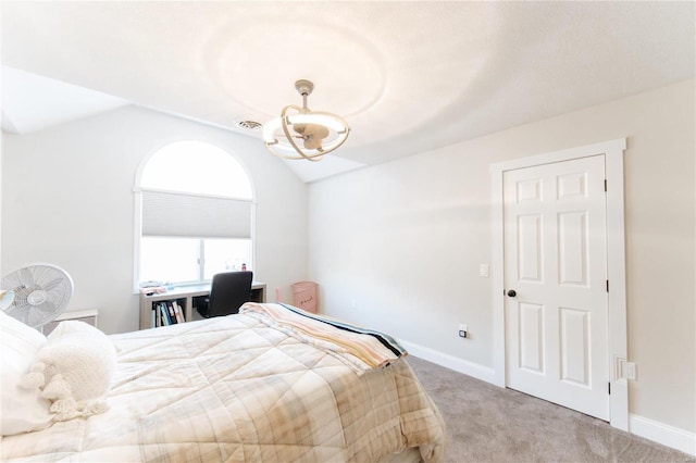 bedroom with light colored carpet and lofted ceiling