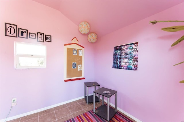 interior space with tile patterned flooring and lofted ceiling