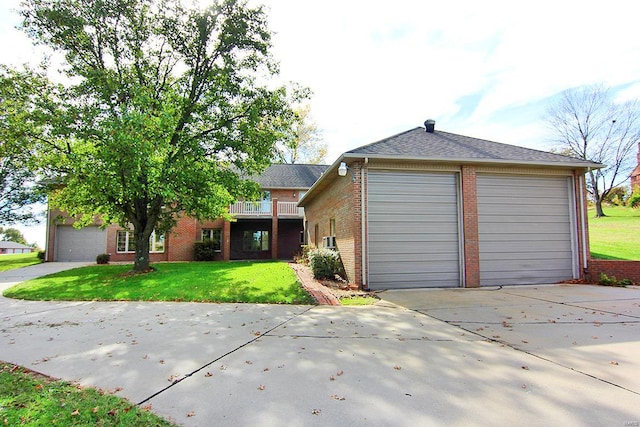 view of front of property featuring a garage and a front lawn