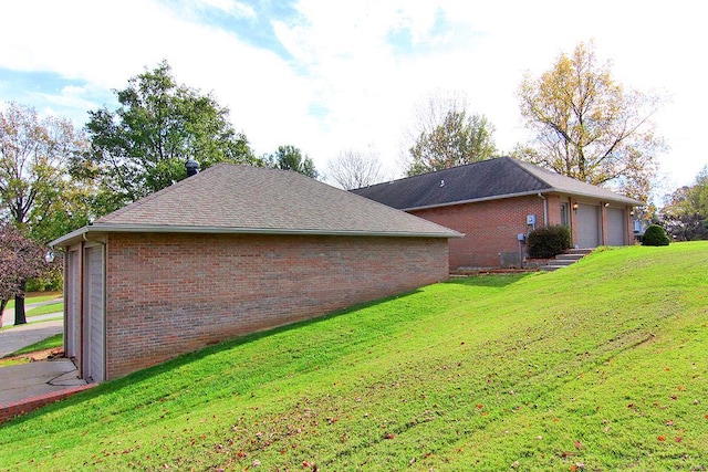 view of side of property with a garage and a yard