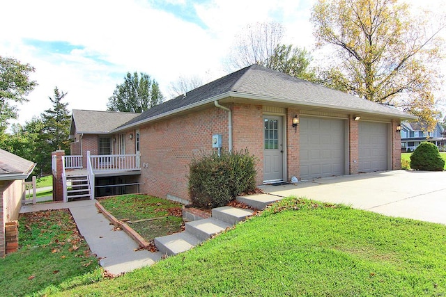 ranch-style house with a garage and a front lawn