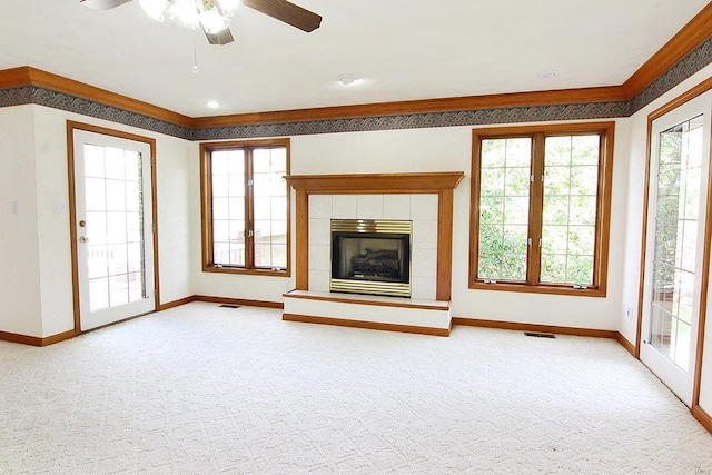 unfurnished living room with carpet, a fireplace, and ceiling fan