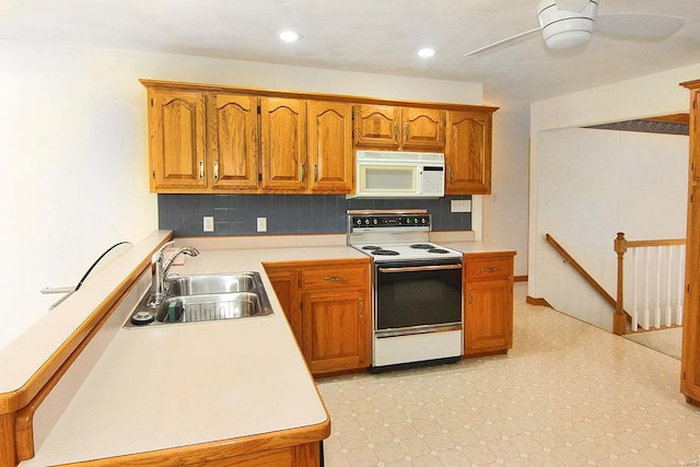 kitchen with backsplash, white appliances, sink, and ceiling fan