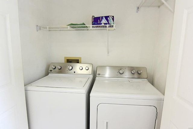 laundry room with washing machine and clothes dryer