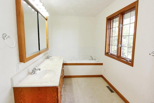 bathroom featuring vanity and a bath