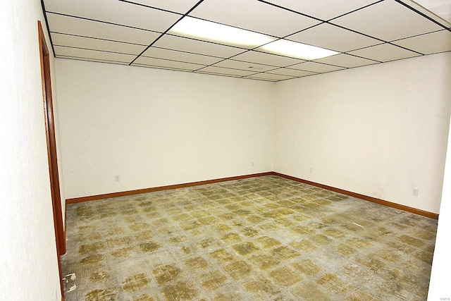 unfurnished room with a drop ceiling